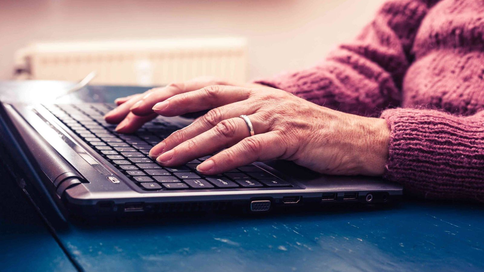 Older woman filling out a Social Security disability application on a laptop