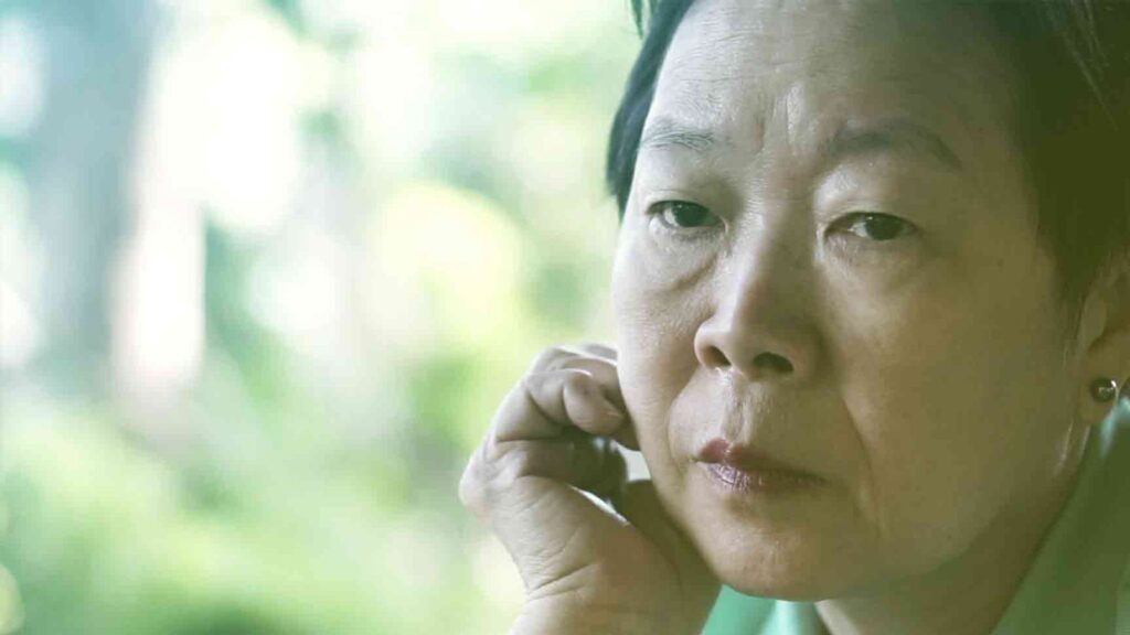 Woman on the phone looking worried after her Social Security disability claim was denied