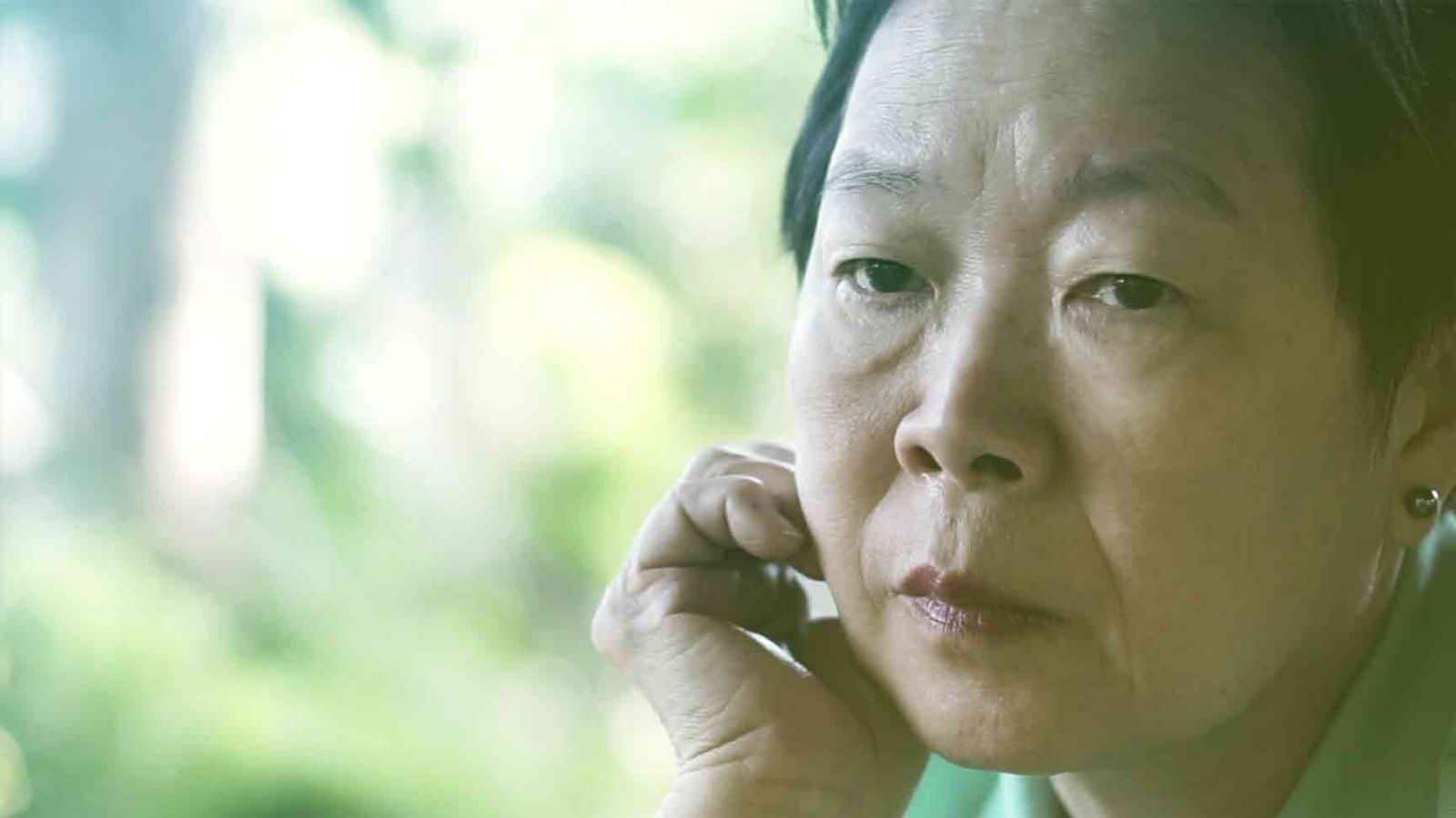Woman on the phone looking worried after her Social Security disability claim was denied